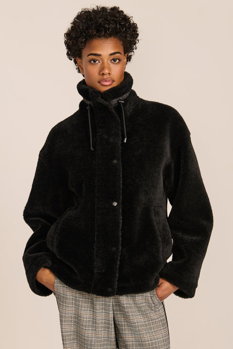 women's sherpa jacket featuring a high funnel collar, adjustable drawcords, concealed snap-front closure and side pockets.