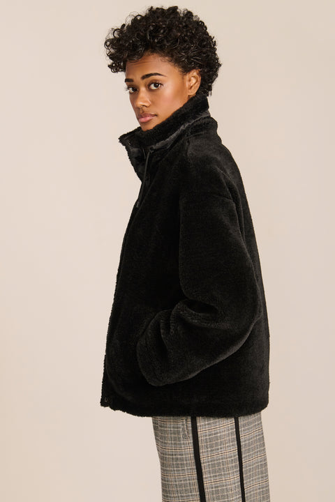 women's sherpa jacket featuring a high funnel collar, adjustable drawcords, concealed snap-front closure and side pockets.