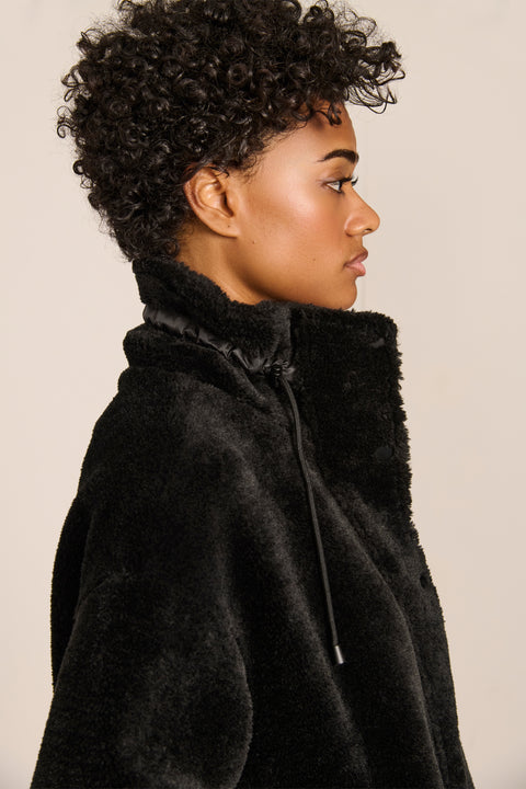 women's sherpa jacket featuring a high funnel collar, adjustable drawcords, concealed snap-front closure and side pockets.