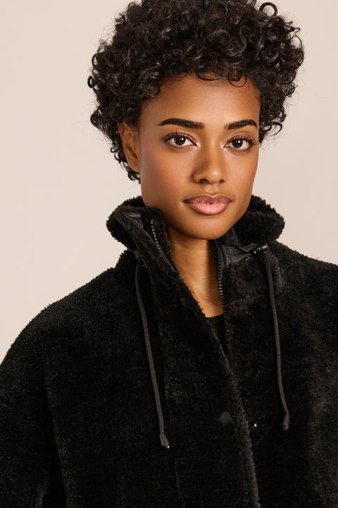 women's sherpa jacket featuring a high funnel collar, adjustable drawcords, concealed snap-front closure and side pockets.