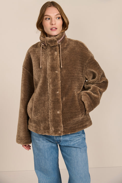 women's sherpa jacket featuring a high funnel collar, adjustable drawcords, concealed snap-front closure and side pockets.