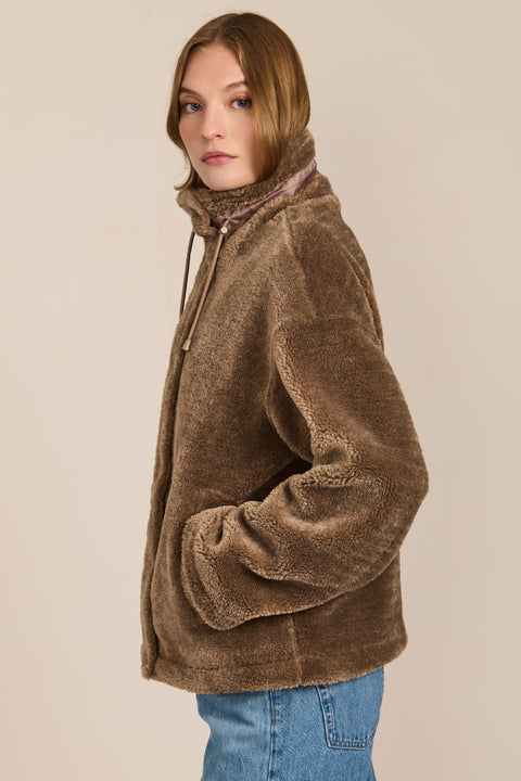 women's sherpa jacket featuring a high funnel collar, adjustable drawcords, concealed snap-front closure and side pockets.