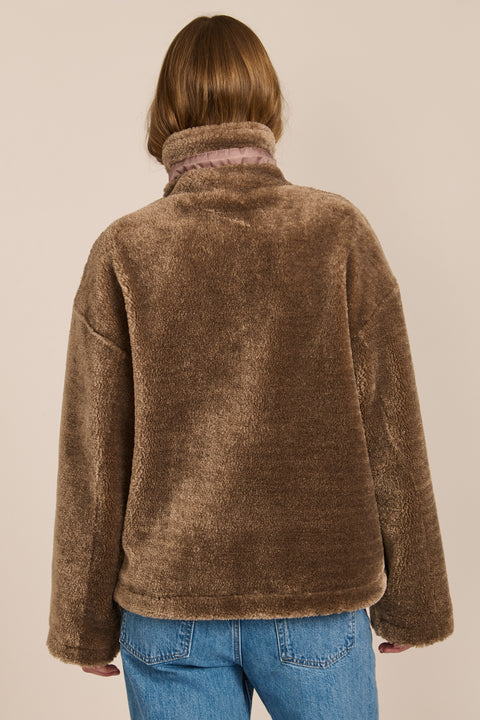 women's sherpa jacket featuring a high funnel collar, adjustable drawcords, concealed snap-front closure and side pockets.