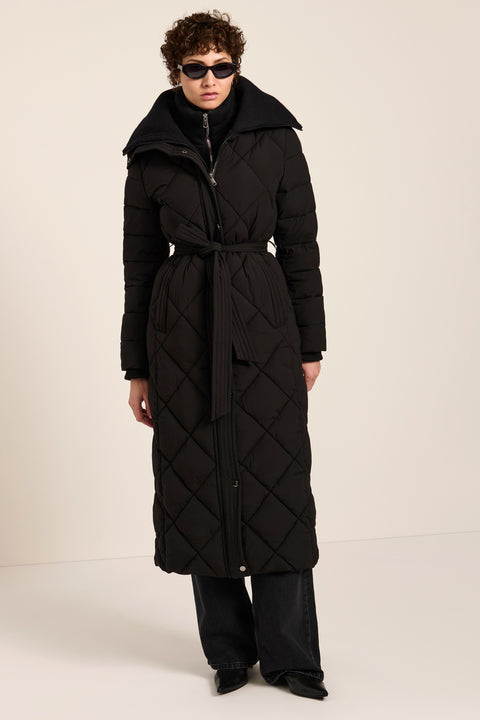 Belted quilted puffer coat with oversized diamond quilting, removable knit bib and stand collar.