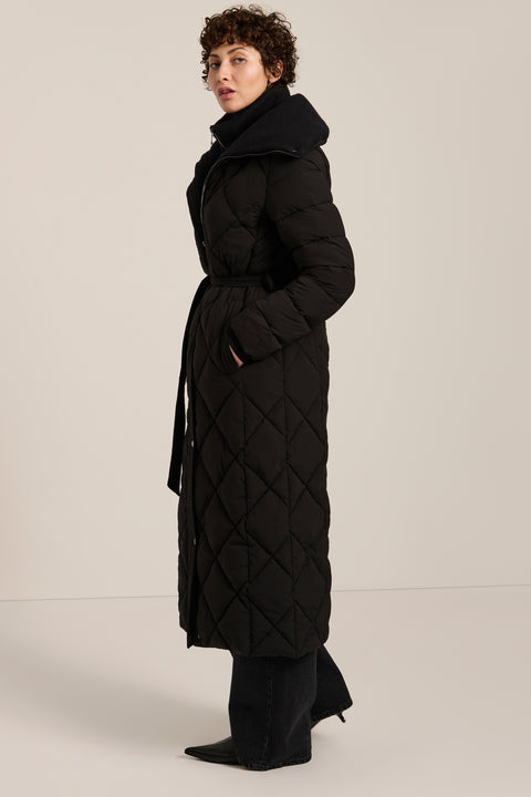 Belted quilted puffer coat with oversized diamond quilting, removable knit bib and stand collar.