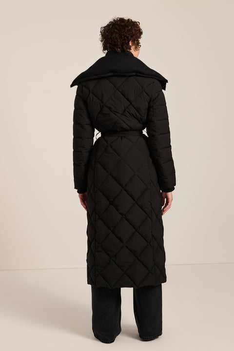 Belted quilted puffer coat with oversized diamond quilting, removable knit bib and stand collar.