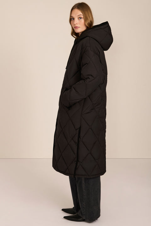 Oversized long puffer coat with diamond quilting, corduroy trim, hood, welt pockets, and Ecoplume insulation.
