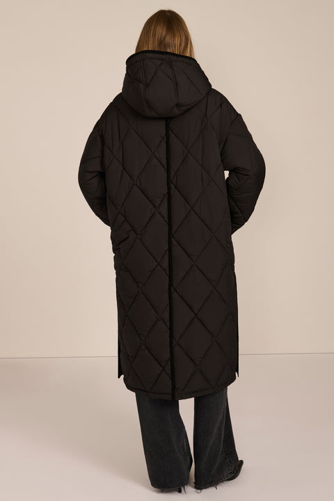 Oversized long puffer coat with diamond quilting, corduroy trim, hood, welt pockets, and Ecoplume insulation.