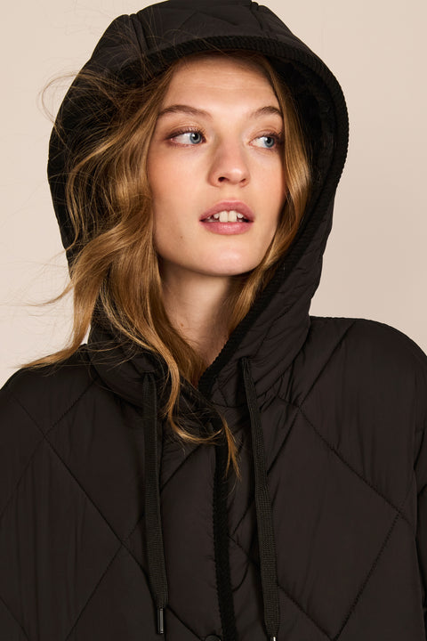 Oversized long puffer coat with diamond quilting, corduroy trim, hood, welt pockets, and Ecoplume insulation.