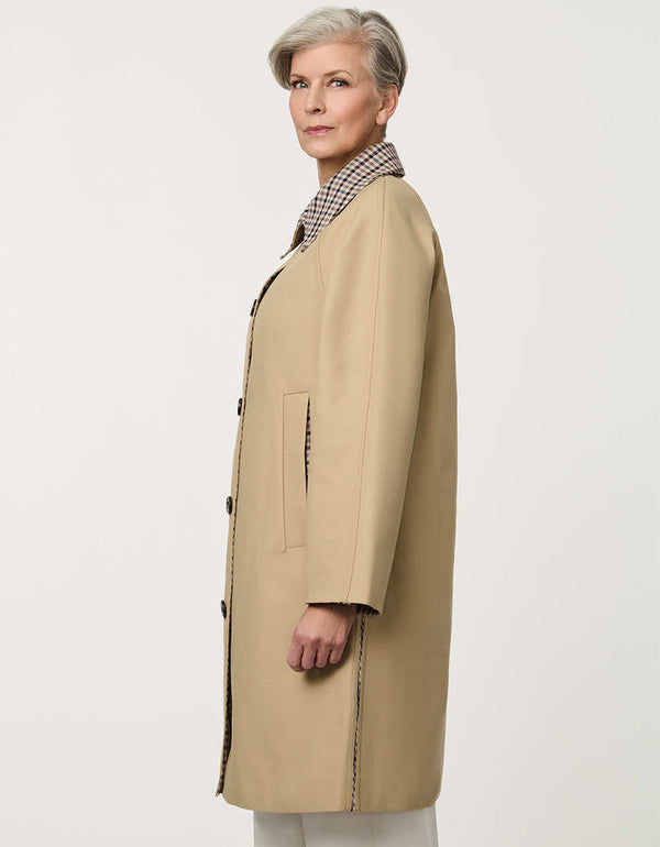 Women’s khaki trench coat with a streamlined silhouette, button front, side pockets, and contrasting plaid collar.