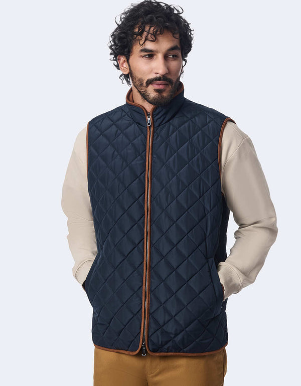 men's quilted vest made with sustainable materials. Lightweight style with contrast lining and two-way zipper.