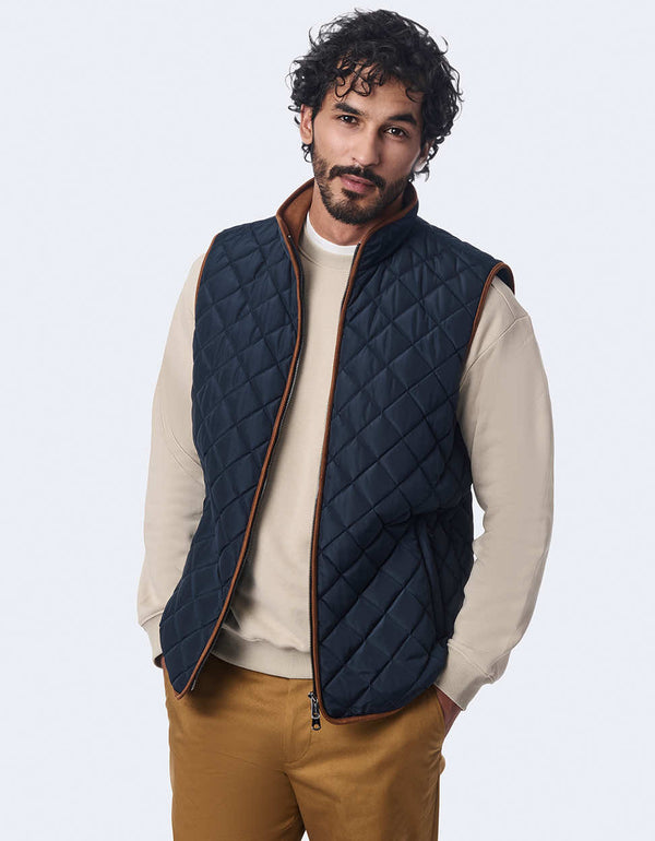 men's quilted vest made with sustainable materials. Lightweight style with contrast lining and two-way zipper.