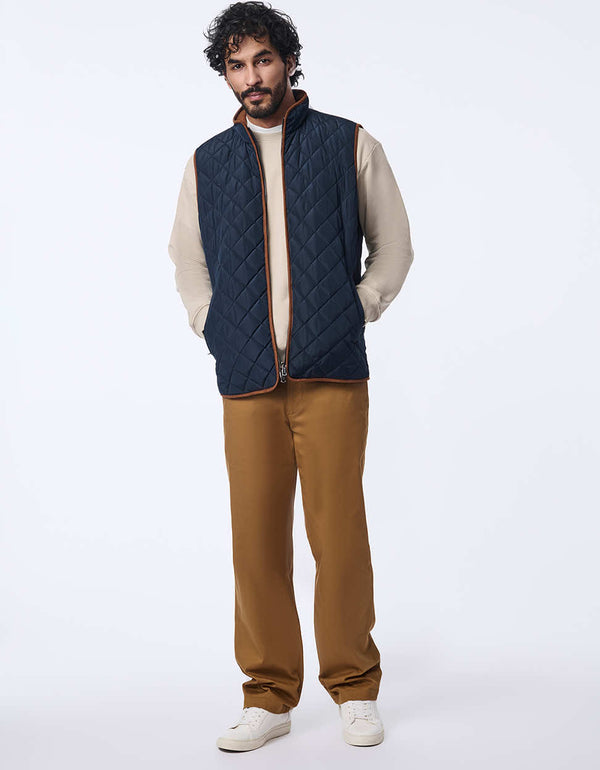 men's quilted vest made with sustainable materials. Lightweight style with contrast lining and two-way zipper.