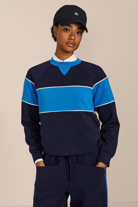 Women's navy and blue colorblock soft scuba sweatshirt with contrast piping and crew neckline.