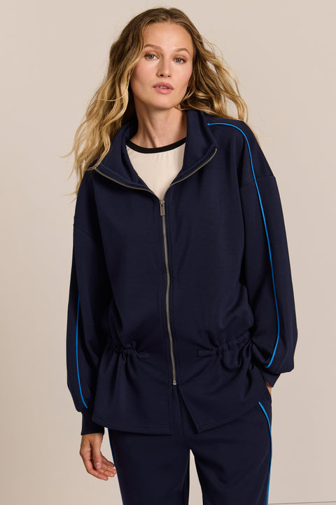 women's soft scuba full-zip jacket with blue contrast piping, high funnel collar and cinched waist.