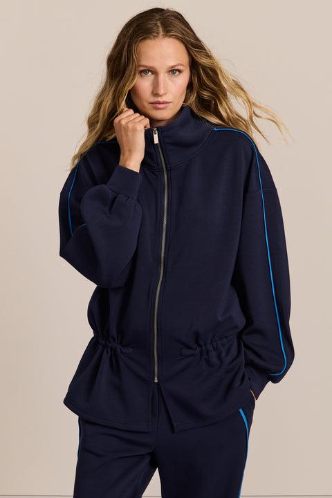 women's soft scuba full-zip jacket with blue contrast piping, high funnel collar and cinched waist.