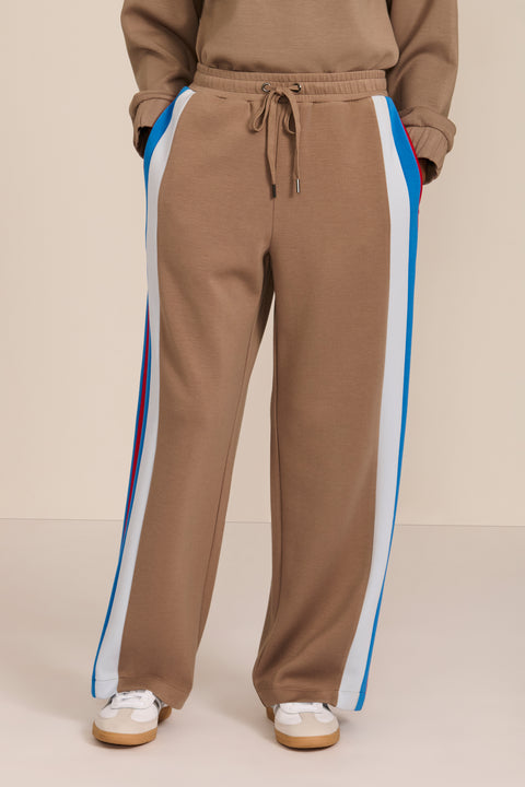 Women's soft scuba wide-leg pants with blue, white and red colorblocked side stripes and drawstring waist.