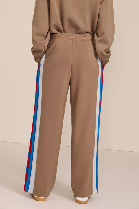 Women's soft scuba wide-leg pants with blue, white and red colorblocked side stripes and drawstring waist.