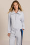 Sporty yet polished. Two ways to wear it, one effortlessly modern layer. Crafted from soft scuba fabric, this relaxed sweatshirt is elevated by a sculptural contrast collar and quarter-zip neckline. Ribbed cuffs and an easy silhouette bring laid-back appeal, while the unexpected colorblocking gives it a distinctly modern finish. The convertible collar can be worn open or zipped into a dramatic funnel neck, while a drawstring hem lets you play with the shape. Pair it with the coordinating pant for an effortl