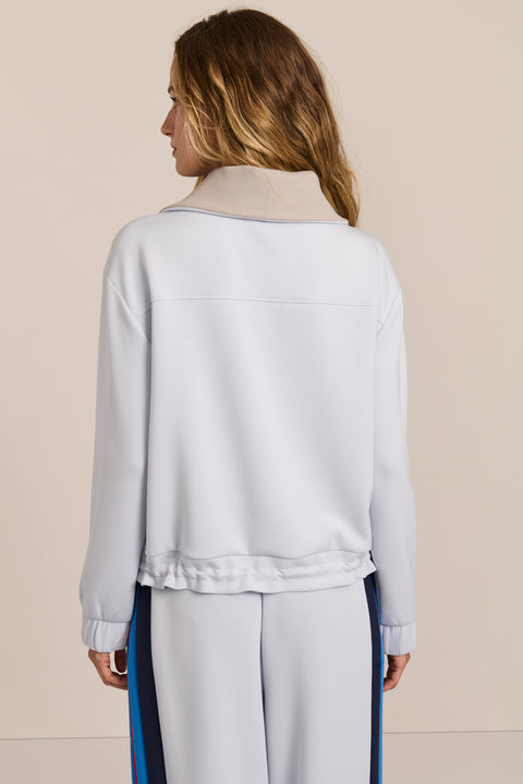 Sporty yet polished. Two ways to wear it, one effortlessly modern layer. Crafted from soft scuba fabric, this relaxed sweatshirt is elevated by a sculptural contrast collar and quarter-zip neckline. Ribbed cuffs and an easy silhouette bring laid-back appeal, while the unexpected colorblocking gives it a distinctly modern finish. The convertible collar can be worn open or zipped into a dramatic funnel neck, while a drawstring hem lets you play with the shape. Pair it with the coordinating pant for an effortl