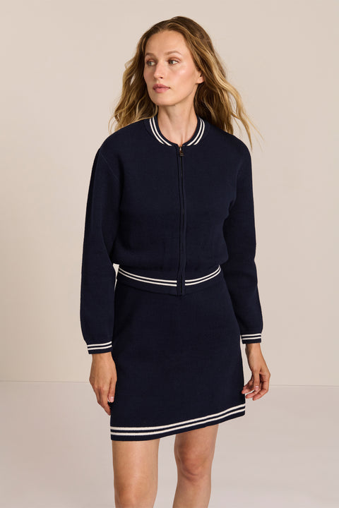 women's navy knit bomber jacket with zip front and ivory striped collar, cuffs and hem.