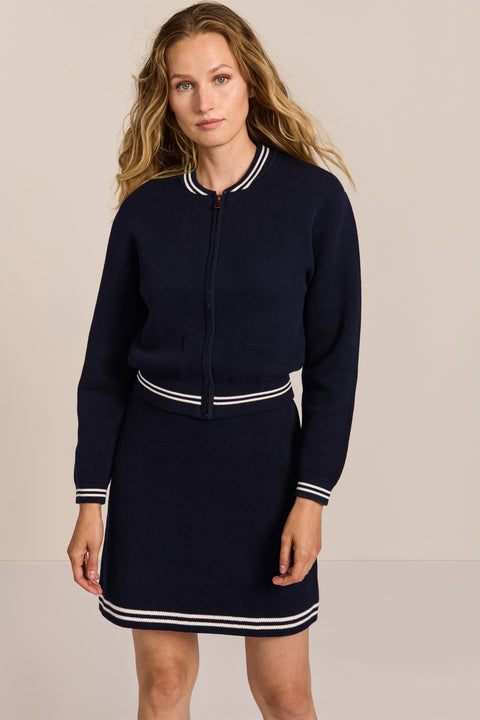 women's navy knit bomber jacket with zip front and ivory striped collar, cuffs and hem.