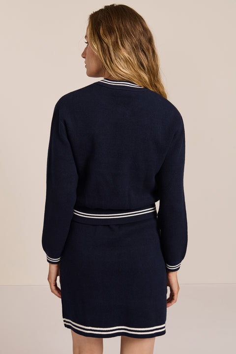 women's navy knit bomber jacket with zip front and ivory striped collar, cuffs and hem.