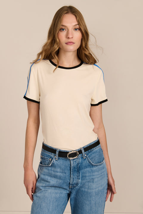 women's ivory short-sleeve ringer tee featuring black contrast trim and blue stripes along the shoulders and sleeves.