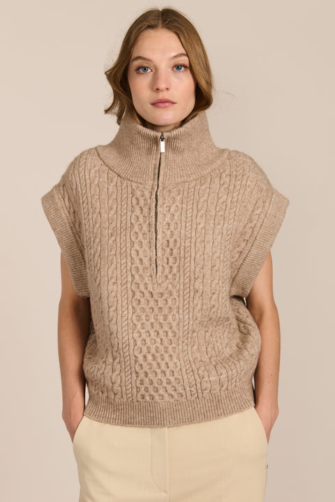 women's cable knit quarter-zip sweater vest with ribbed funnel collar, textured cable stitching and relaxed cap sleeves.