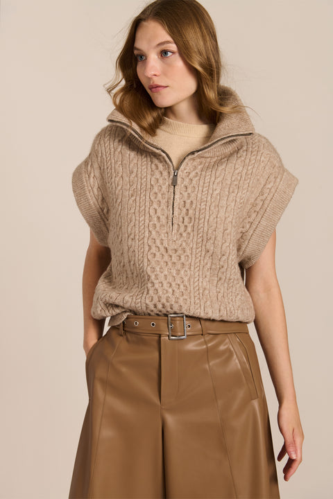 women's cable knit quarter-zip sweater vest with ribbed funnel collar, textured cable stitching and relaxed cap sleeves.