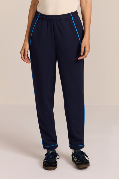 Women's navy soft scuba pull-on pants with blue contrast piping, elastic waistband and tapered leg.