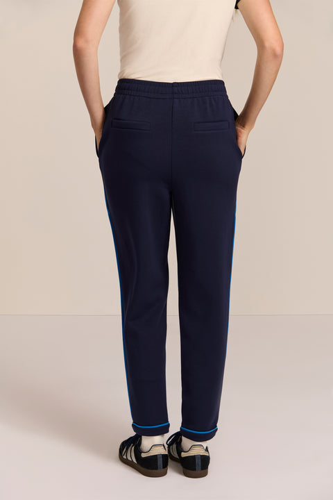 Women's navy soft scuba pull-on pants with blue contrast piping, elastic waistband and tapered leg.