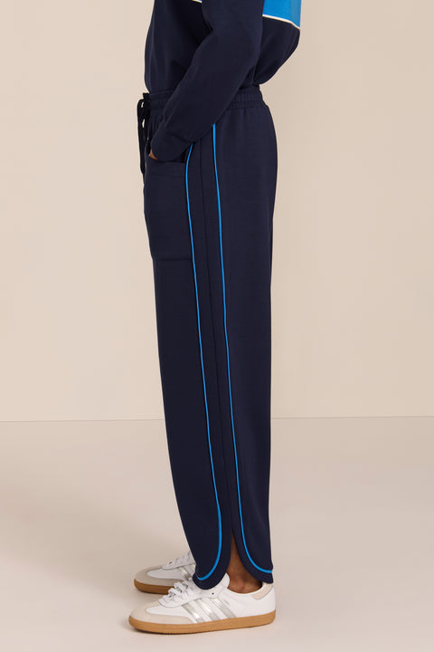 Women's soft scuba wide-leg pants with light blue piping, patch pockets, drawstring waist and side slits.