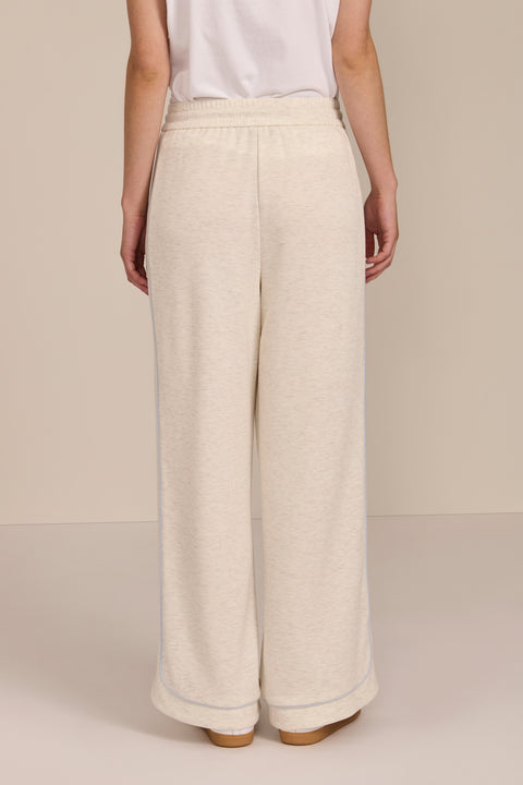 Women's soft scuba wide-leg pants with light blue piping, patch pockets, drawstring waist and side slits.