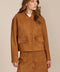 women's camel faux suede bomber jacket with a tonal snap front and flap pockets, styled with the coordinating mini skirt.