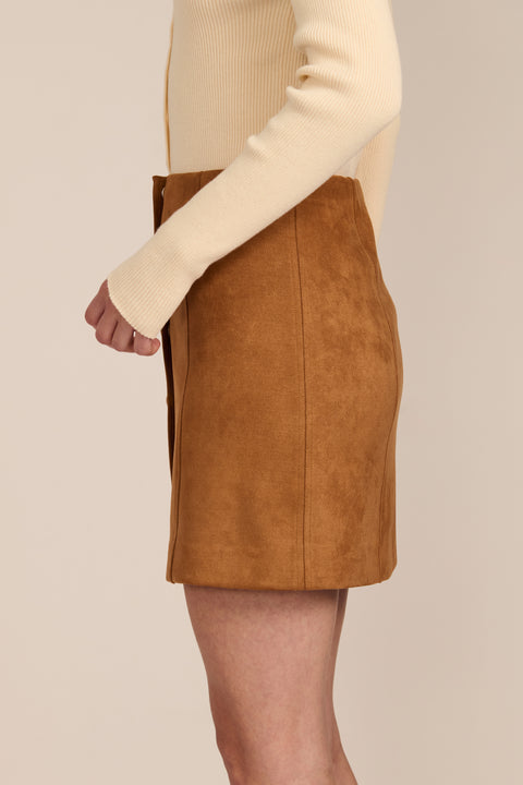 women's camel faux suede mini skirt featuring a tonal covered snap front and clean A-line silhouette.