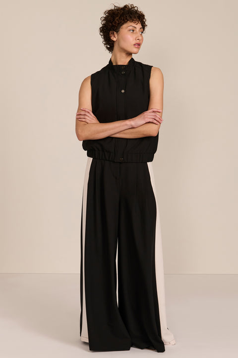 women's black sleeveless utility bomber vest featuring a stand collar, snap-front closure, flap pockets and elasticized hem.