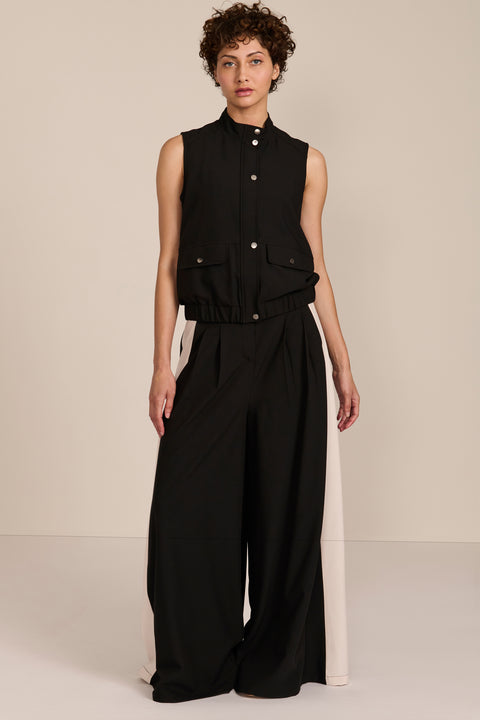 women's black sleeveless utility bomber vest featuring a stand collar, snap-front closure, flap pockets and elasticized hem.