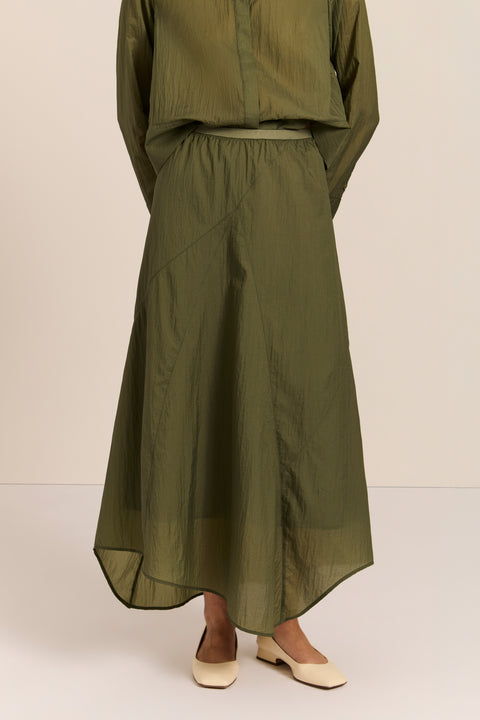 women's asymmetrical maxi skirt in olive green with a fluid silhouette and softly draped hem.