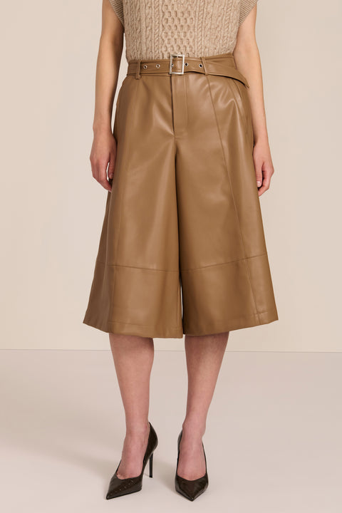 women's camel faux leather culottes featuring a high waist, self belt, wide cropped leg and paneled seam detailing.