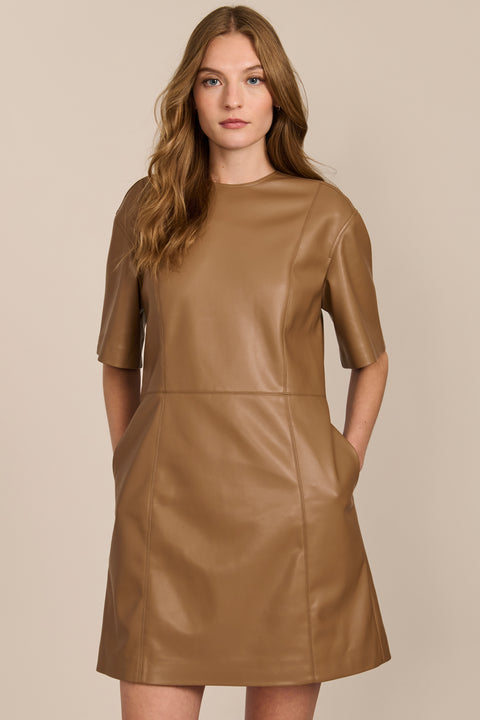 women's camel faux leather shift dress featuring short sleeves, a crew neckline, seam detailing and side pockets.