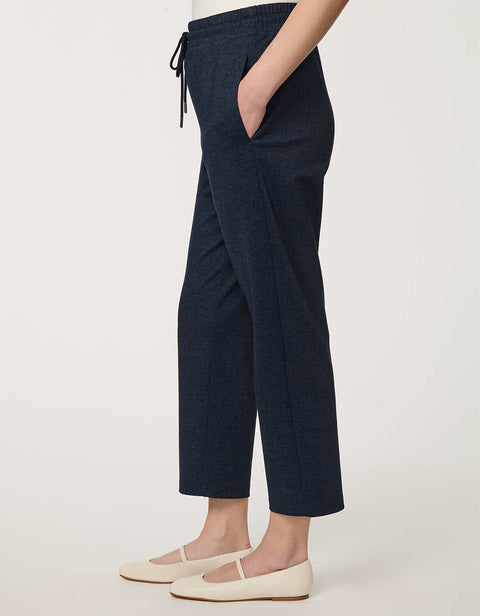 Woman wearing denim-effect Slim Drawstring Pant with cropped straight-leg silhouette and adjustable waist.