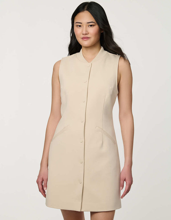 Woman wearing neutral sleeveless Modern Button Down Vest Dress with crew neckline and full button-front closure.