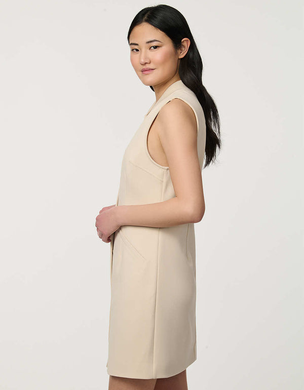 Woman wearing neutral sleeveless Modern Button Down Vest Dress with crew neckline and full button-front closure.
