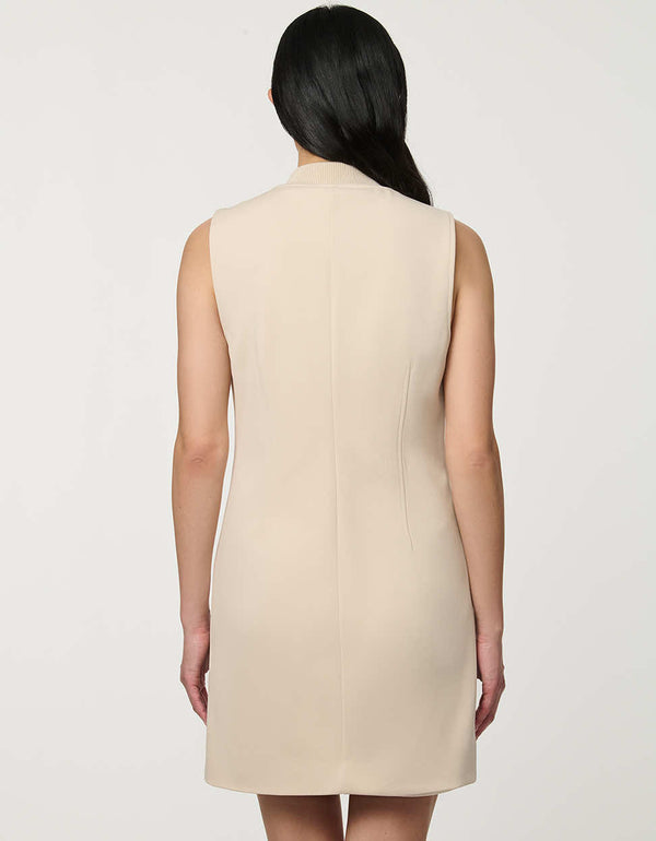 Woman wearing neutral sleeveless Modern Button Down Vest Dress with crew neckline and full button-front closure.