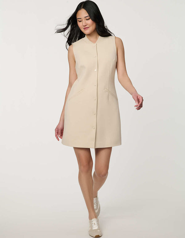 Woman wearing neutral sleeveless Modern Button Down Vest Dress with crew neckline and full button-front closure.