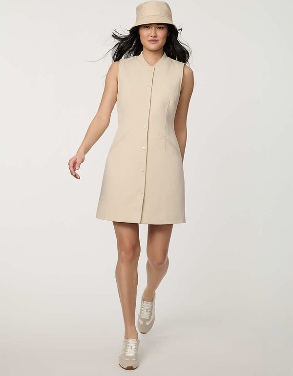 Woman wearing neutral sleeveless Modern Button Down Vest Dress with crew neckline and full button-front closure.