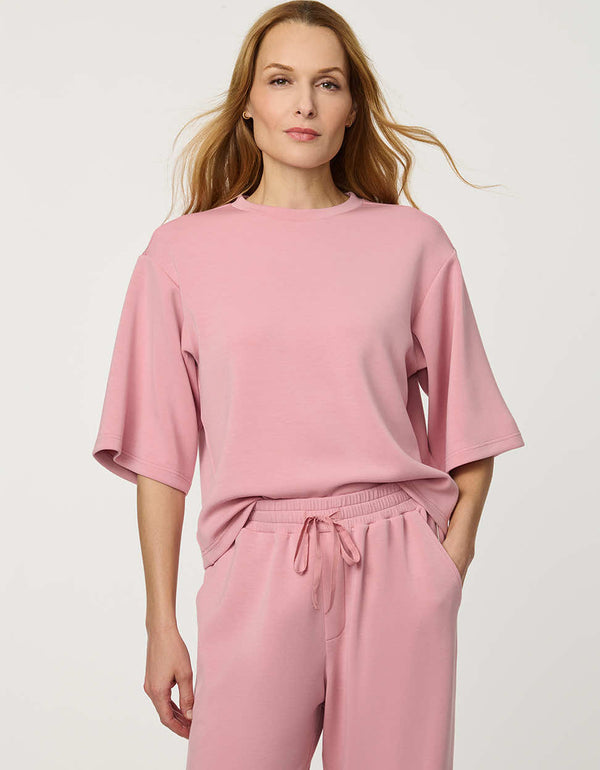 Woman wearing Relaxed Scuba Drop-Shoulder Tee with elbow-length sleeves and modern oversized silhouette.
