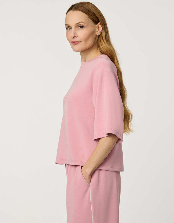 Woman wearing Relaxed Scuba Drop-Shoulder Tee with elbow-length sleeves and modern oversized silhouette.