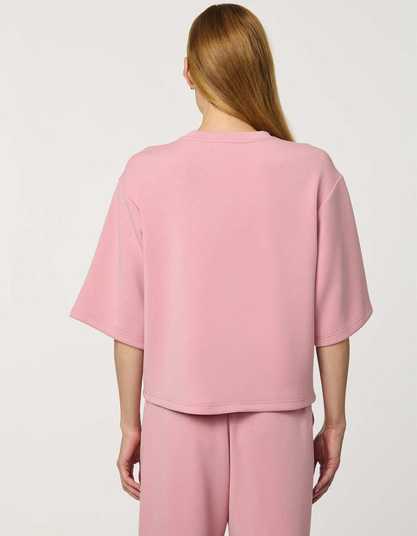 Woman wearing Relaxed Scuba Drop-Shoulder Tee with elbow-length sleeves and modern oversized silhouette.